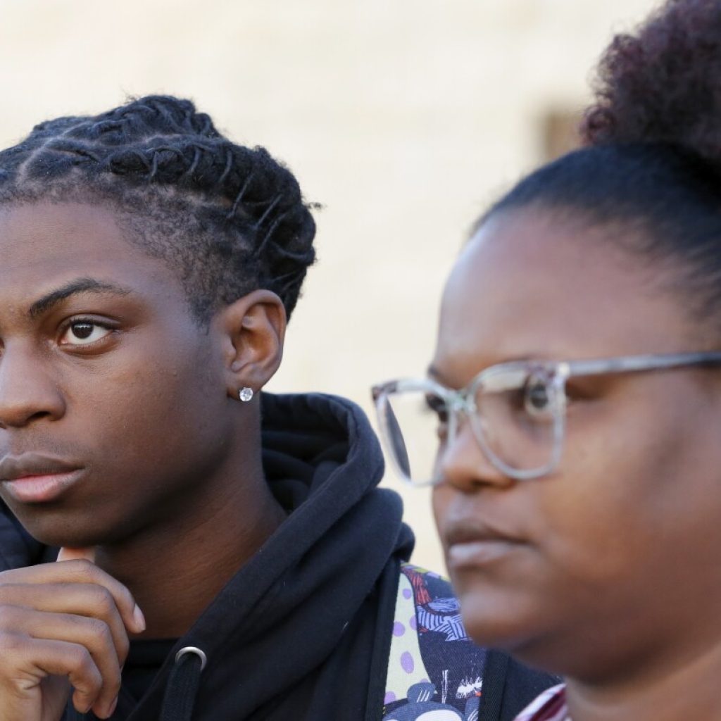 Black student suspended over his hairstyle to be sent to an alternative education program | AP News