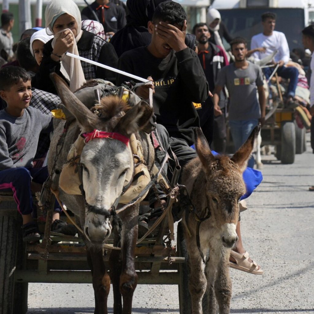 Weary families trudge through Gaza streets, trying to flee the north before Israel’s invasion | AP News