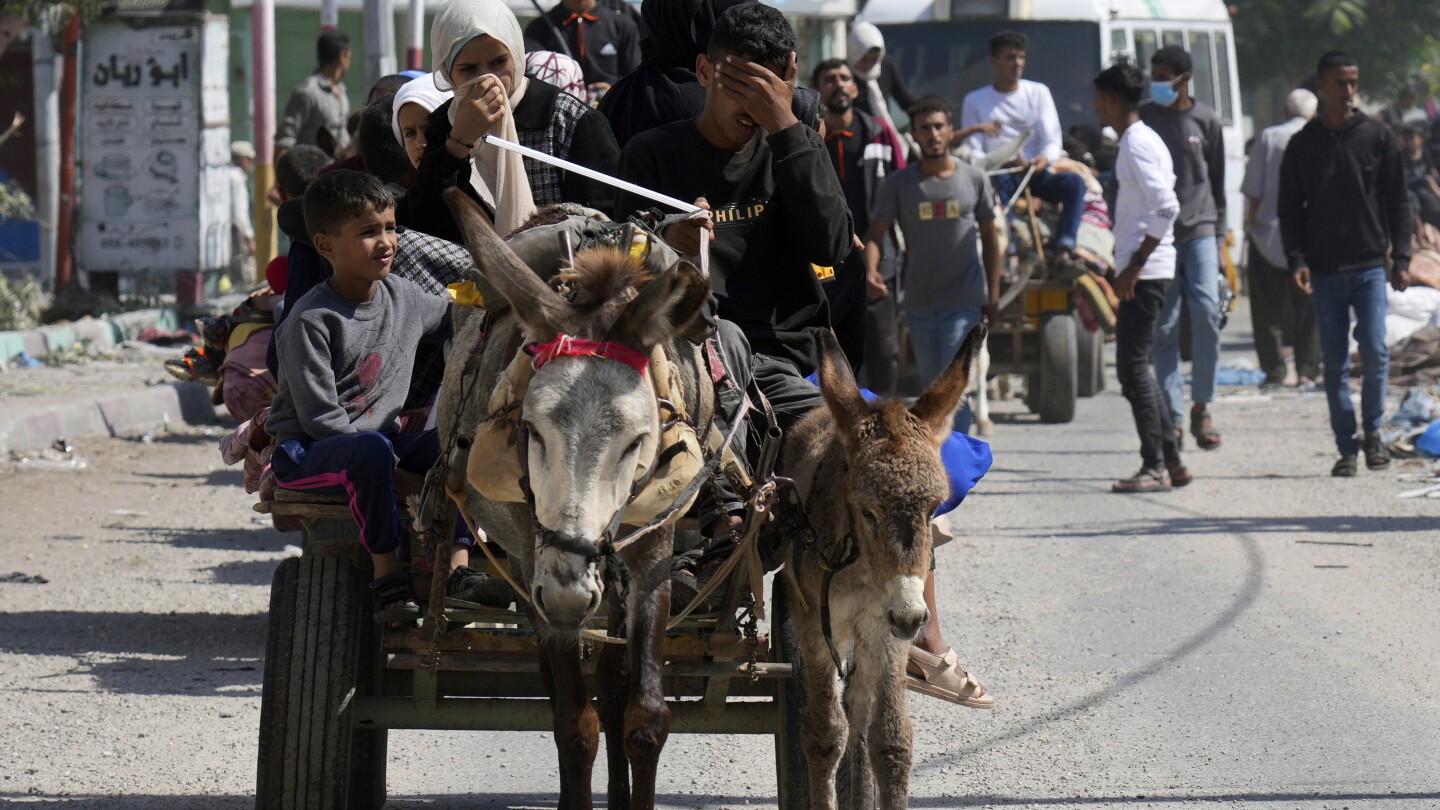 Weary families trudge through Gaza streets, trying to flee the north before Israel’s invasion | AP News