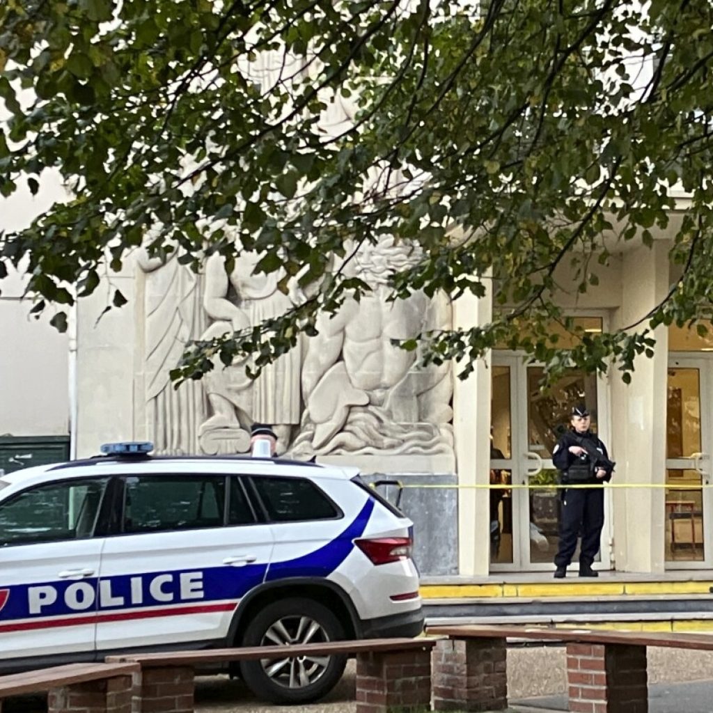 French schools hold a moment of silence in an homage to a teacher killed in a knife attack | AP News