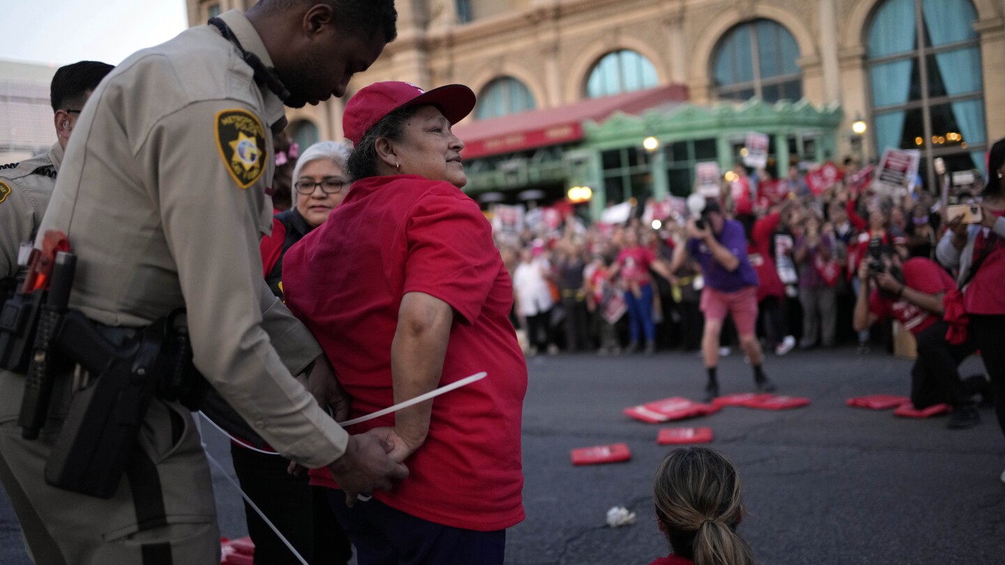 Dozens of union workers arrested on Las Vegas Strip for blocking traffic as thousands rally | AP News