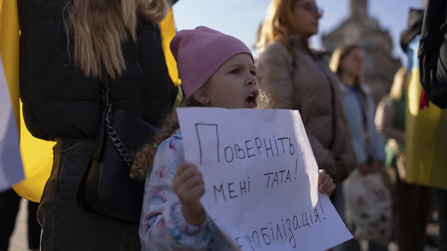 War-weary mothers, wives and children of Ukrainian soldiers demand a cap on military service time | AP News