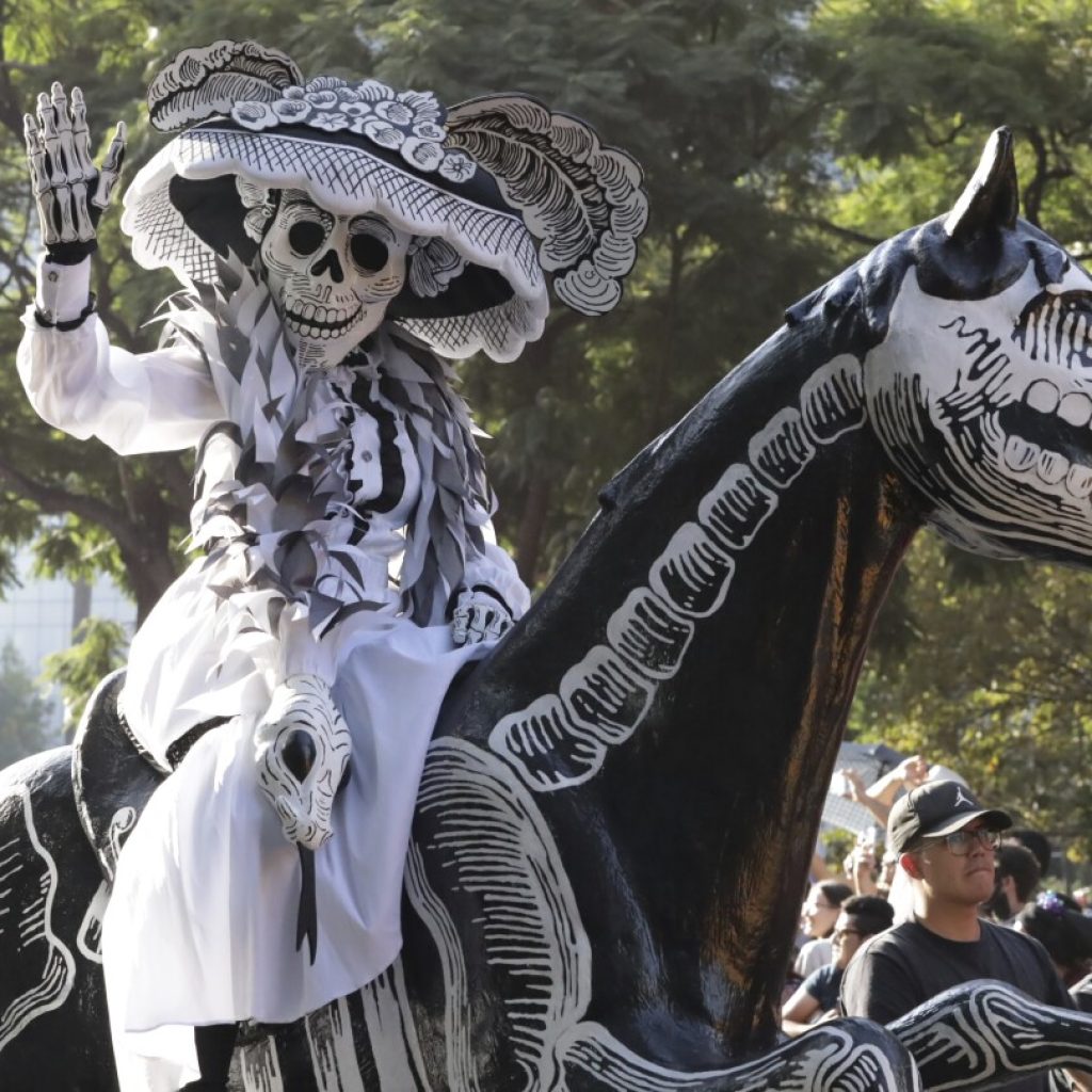 Skeleton marching bands and dancers in butterfly skirts join in Mexico City’s Day of the Dead parade | AP News