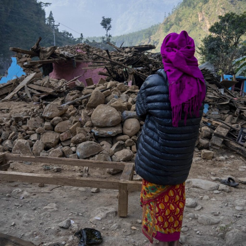 Aid trickles in to Nepal villages struck by earthquake as survivors salvage belongings from rubble | AP News