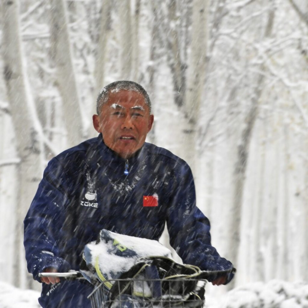 Northeast China sees first major blizzard this season and forecasters warn of record snowfall | AP News