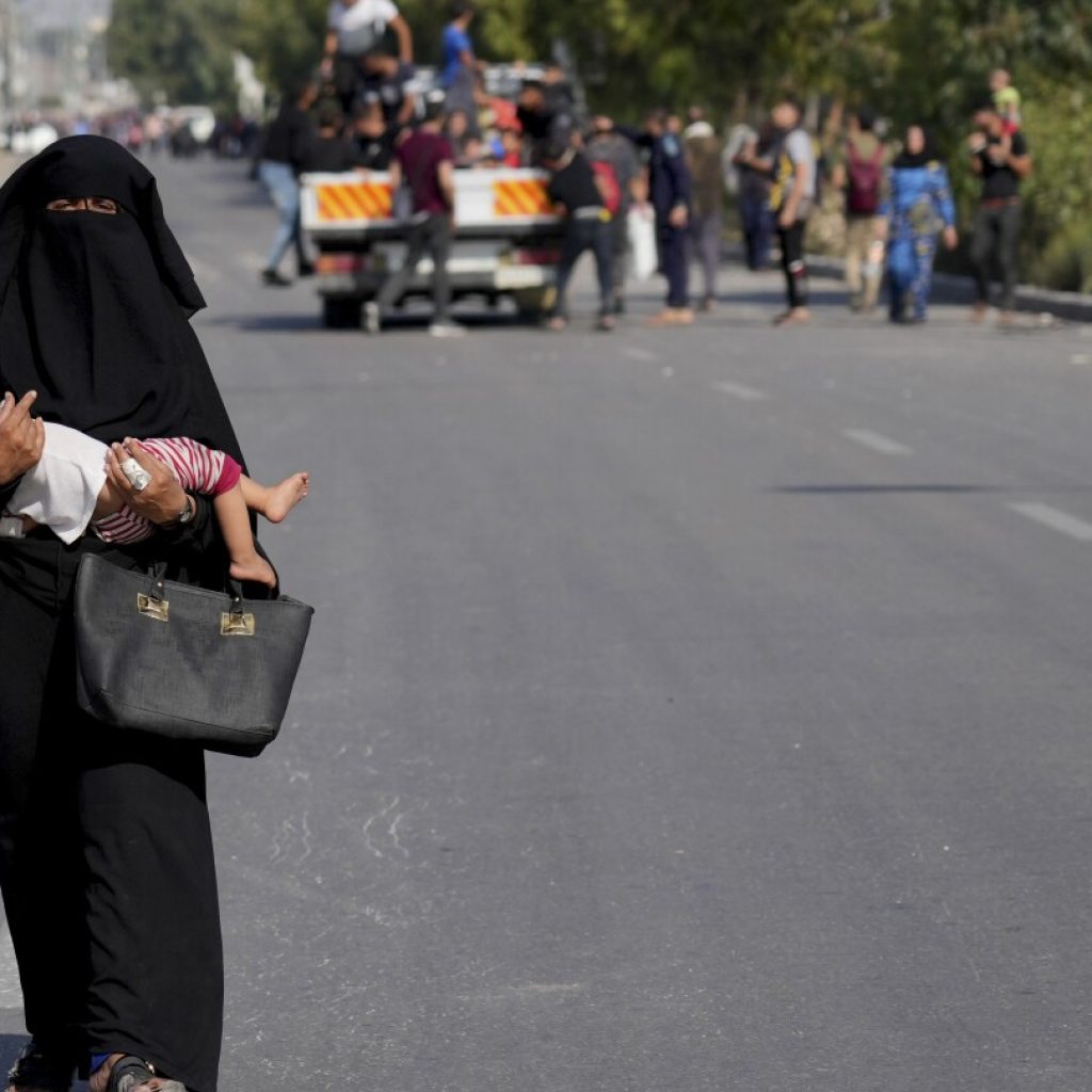 Civilians fleeing northern Gaza’s combat zone report a terrifying journey on foot past Israeli tanks | AP News