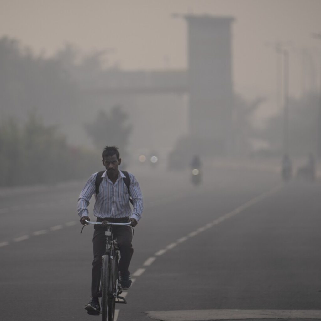 Masks are back, construction banned and schools shut as toxic air engulfs New Delhi | AP News