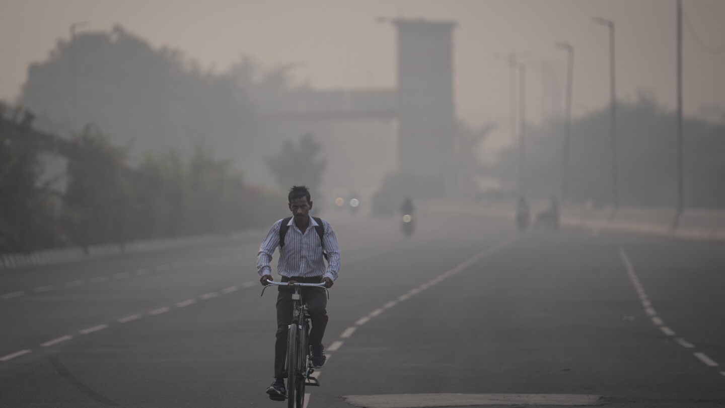 Masks are back, construction banned and schools shut as toxic air engulfs New Delhi | AP News