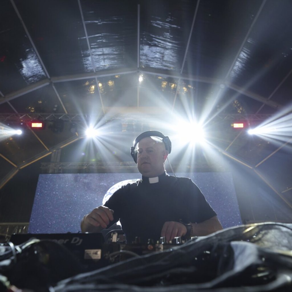 As a DJ, village priest in Portugal cues up faith and electronic dance music for global youth | AP News