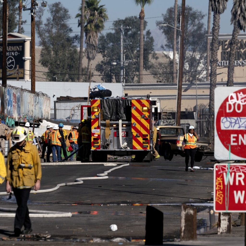 Los Angeles motorists urged to take public transport after massive fire closes interstate | AP News