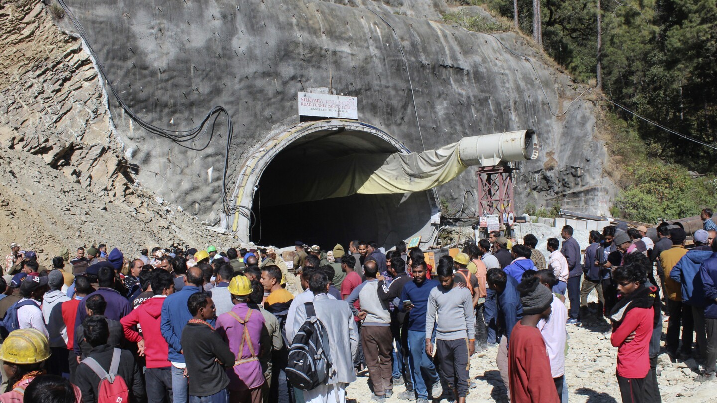 Indian rescuers prepare to drill to reach 40 workers trapped in a collapse tunnel since weekend | AP News