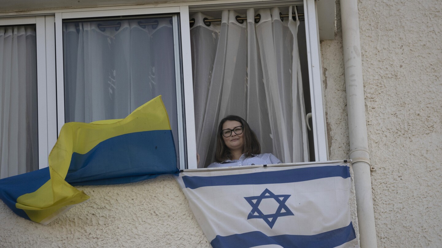 Ukrainians who fled their country for Israel find themselves yet again living with war | AP News