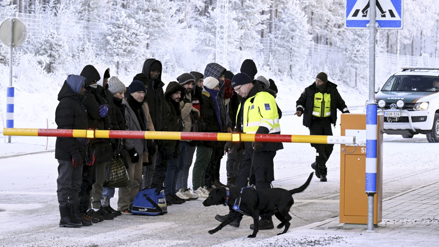 Finland erects barriers at border with Russia to control influx of migrants, closes crossing points | AP News