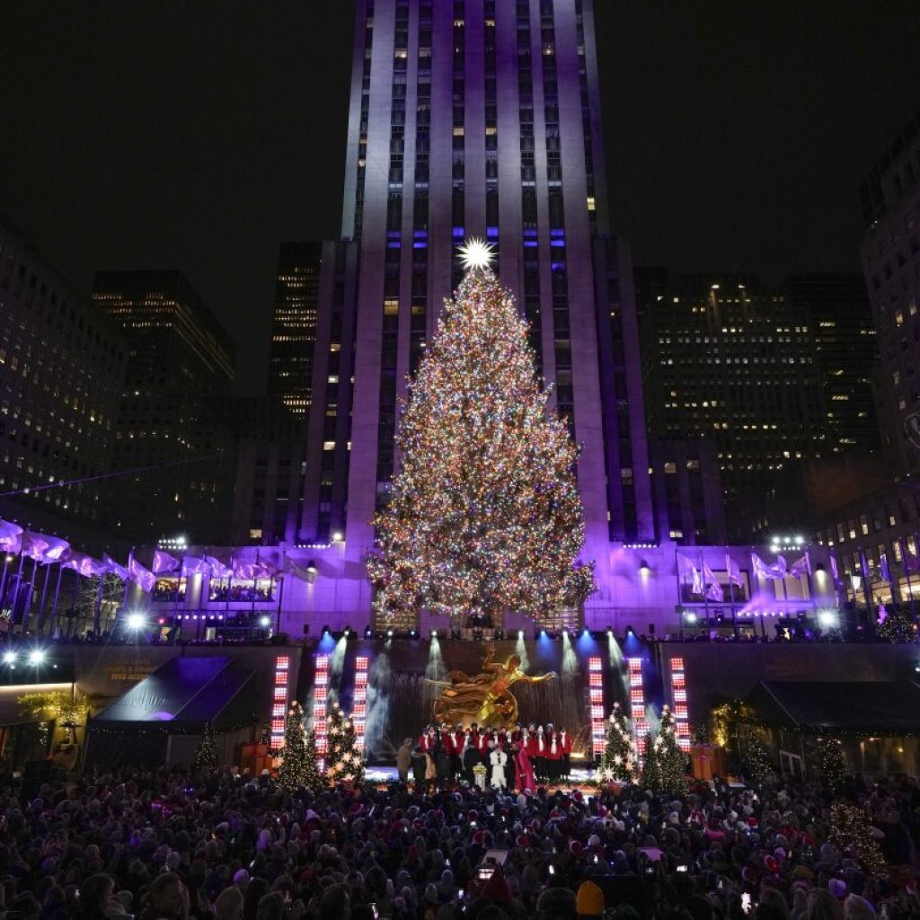 Iconic Christmas tree at Rockefeller Center illuminated | AP News