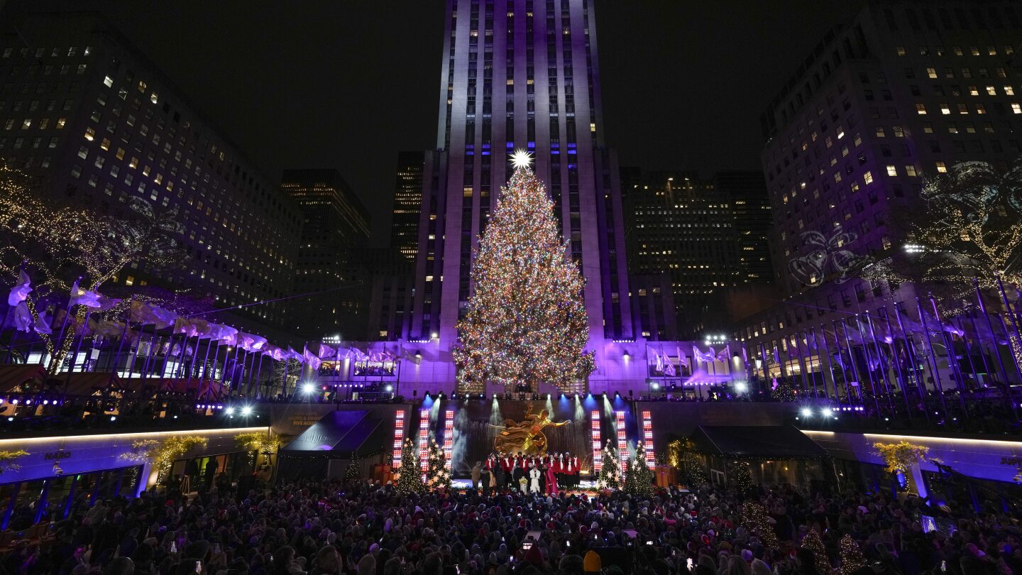 Iconic Christmas tree at Rockefeller Center illuminated | AP News