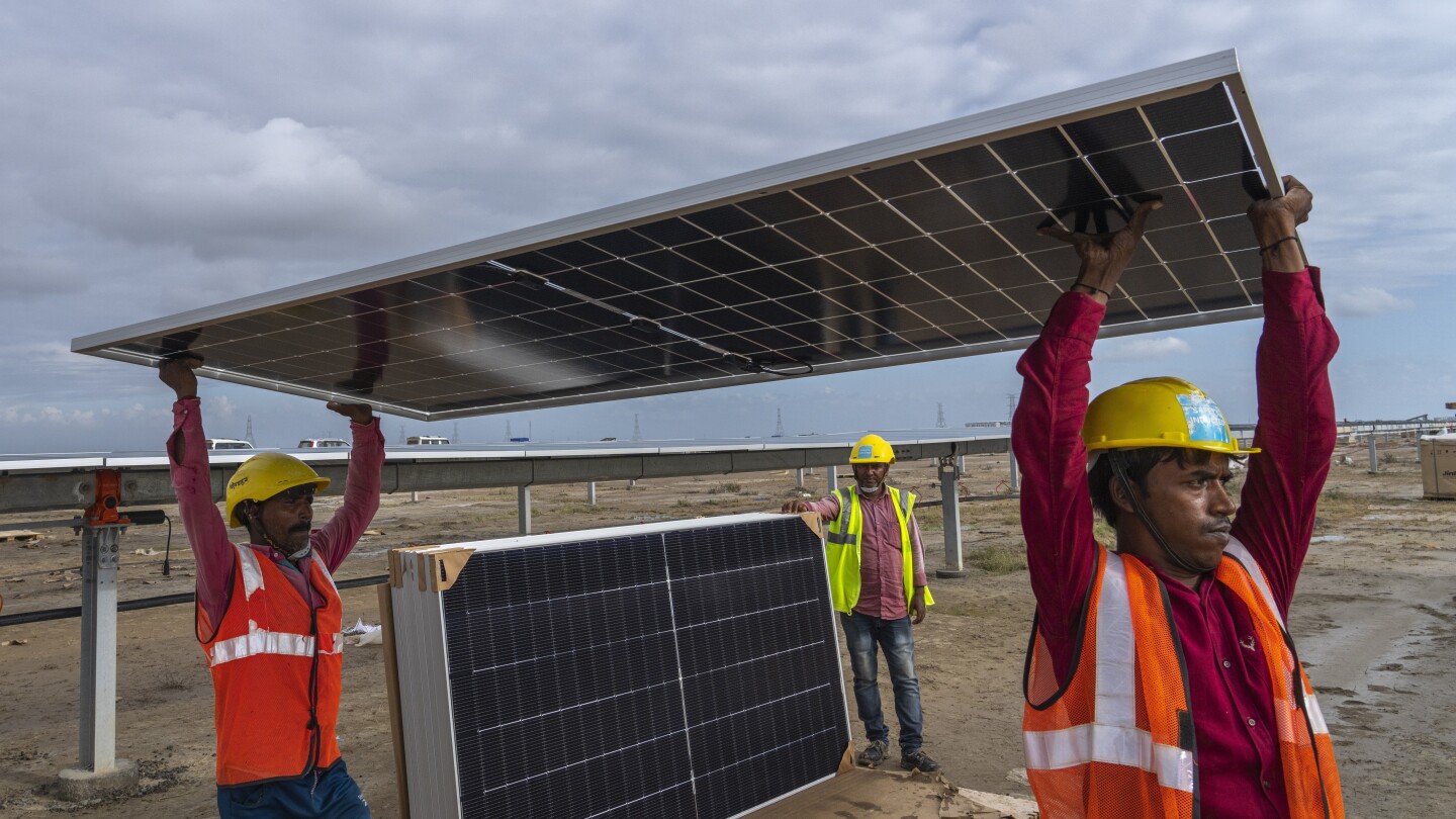 In the salt deserts bordering Pakistan, India builds its largest renewable energy project | AP News