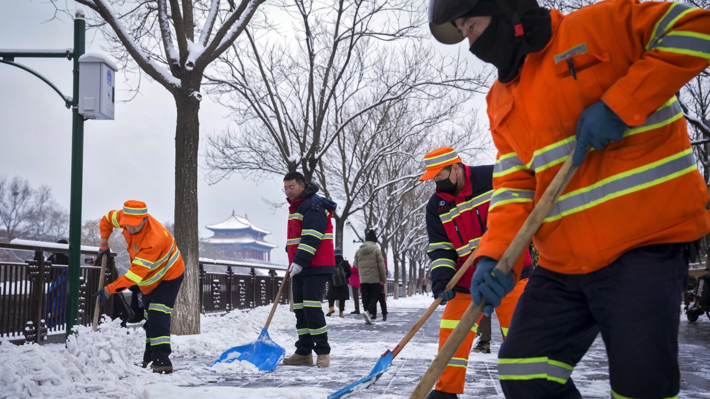 Snow blankets northern China, closing roads and schools and suspending train service | AP News