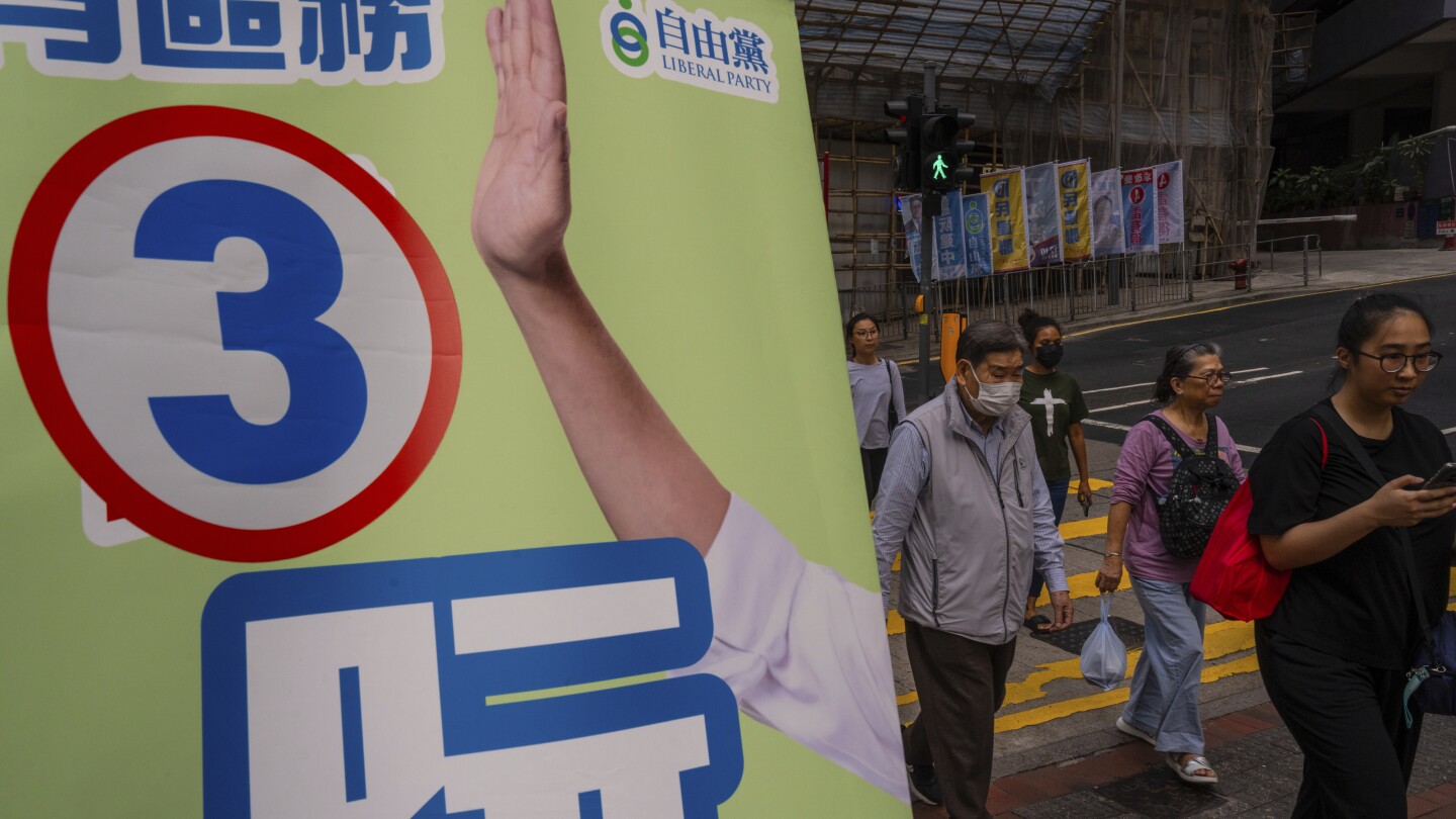 Hong Kong leader praises election turnout as voter numbers hit record low | AP News