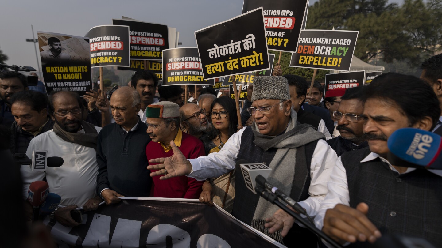 India’s opposition lawmakers protest their suspension from Parliament by the government | AP News