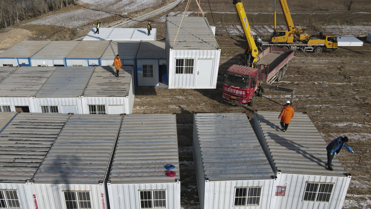 China has started erecting temporary housing units after an earthquake destroyed 14,000 homes | AP News