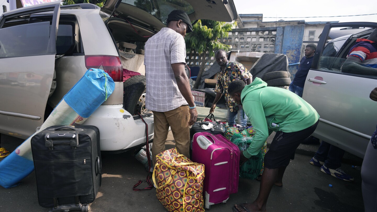 Nigeria slashes transport fees during the holidays to ease some of the pain of austerity measures | AP News