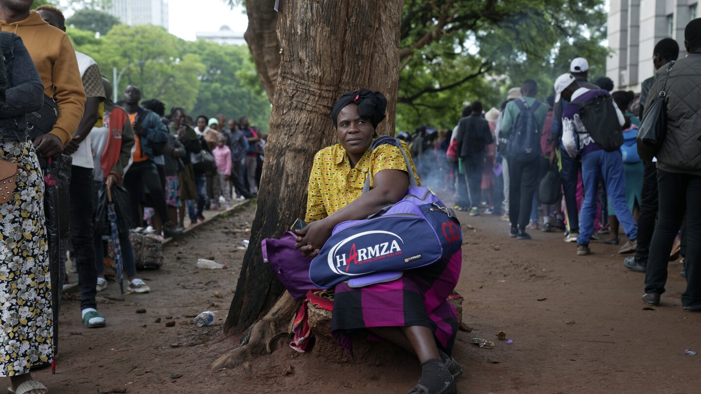 A Christmas rush to get passports to leave Zimbabwe is fed by economic gloom and a price hike | AP News