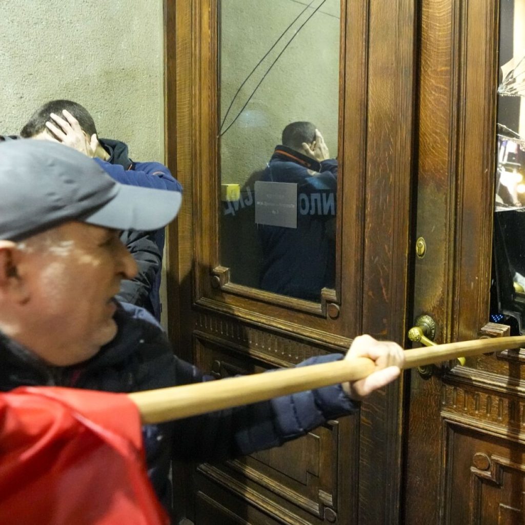 Police in Serbia fire tear gas at election protesters threatening to storm capital’s city hall | AP News