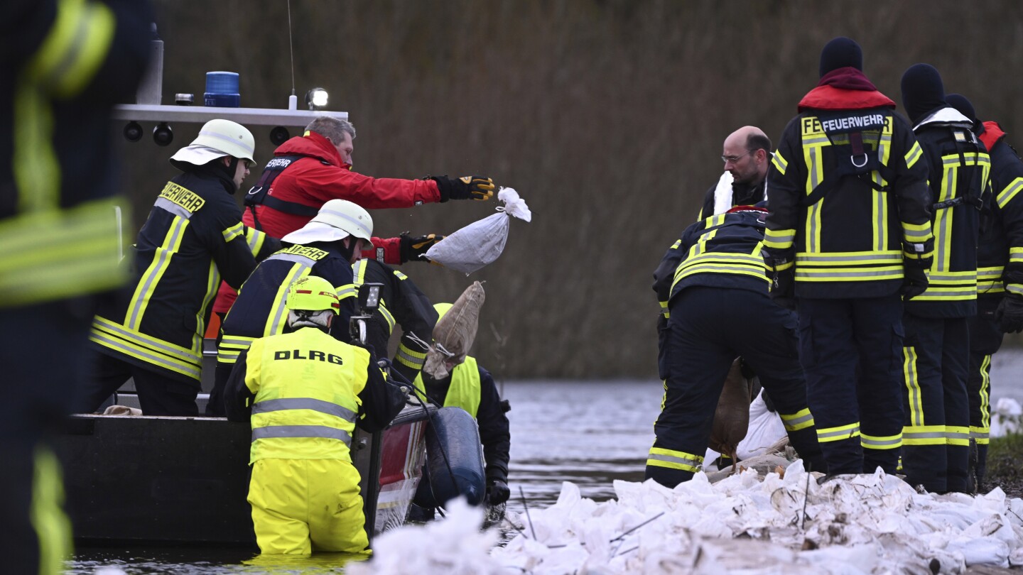 Towns reinforce dikes as heavy rains send rivers over banks in Germany and the Netherlands | AP News