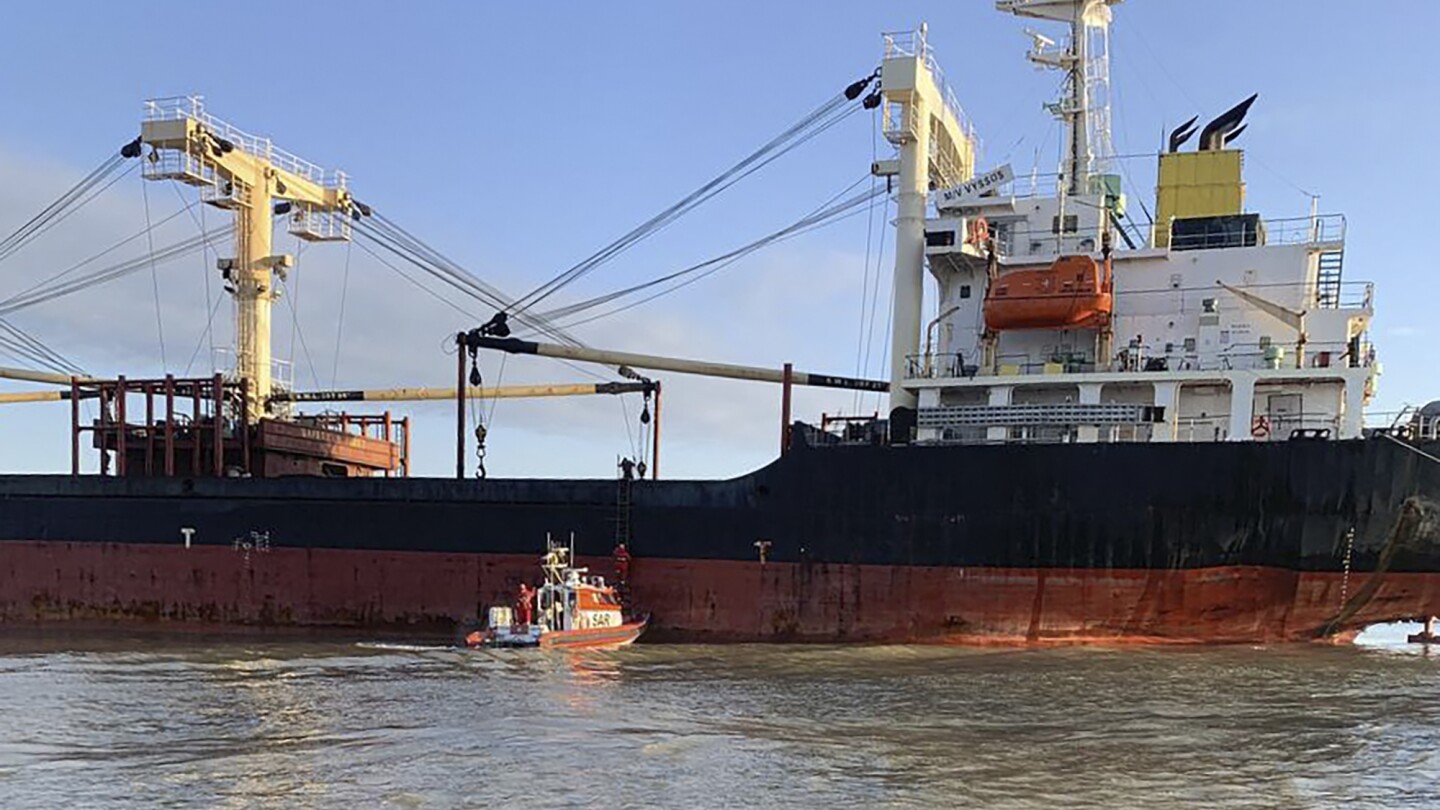 A cargo ship picking up Ukrainian grain hits a Russian floating mine in the Black Sea, officials say | AP News