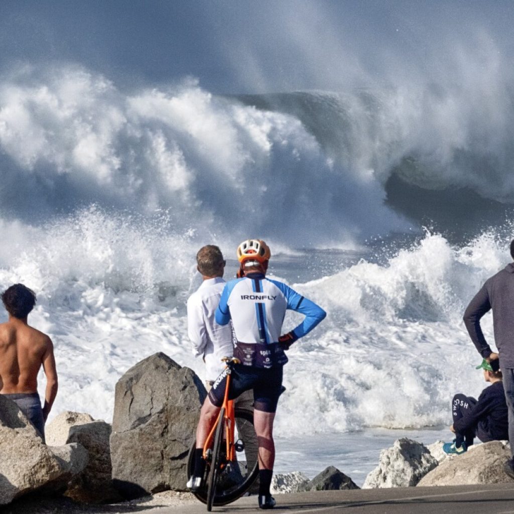 Huge surf pounds California coast and Hawaii, flooding some areas | AP News