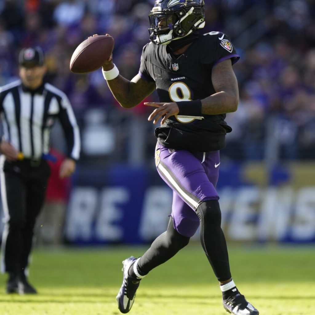 Lamar Jackson’s perfect day clinches top seed in AFC for Ravens, fuels rout of Dolphins | AP News