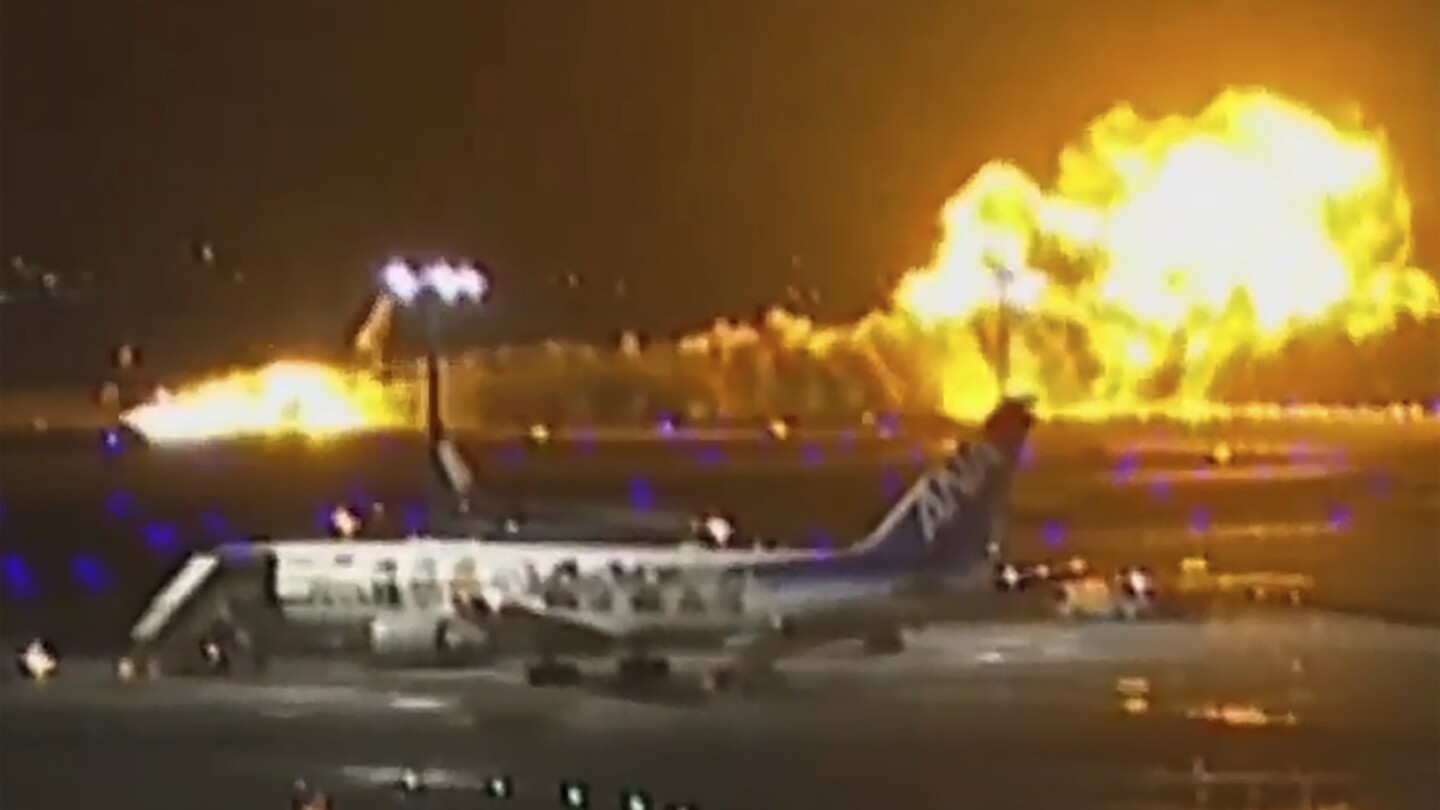 Plane catches fire on runway at Japan’s Haneda airport after collision, passengers reportedly safe | AP News