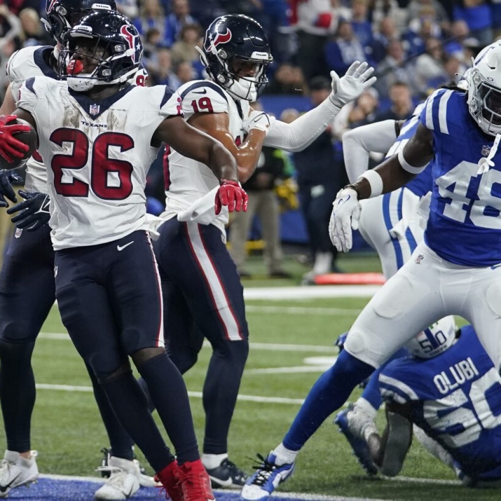 Texans wrap up playoff spot with 23-19 victory over Colts | AP News