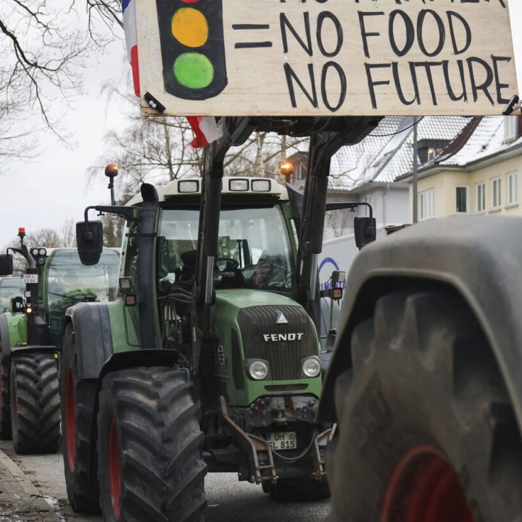 German farmers block roads with tractors and stage protests against plan to scrap diesel tax breaks | AP News