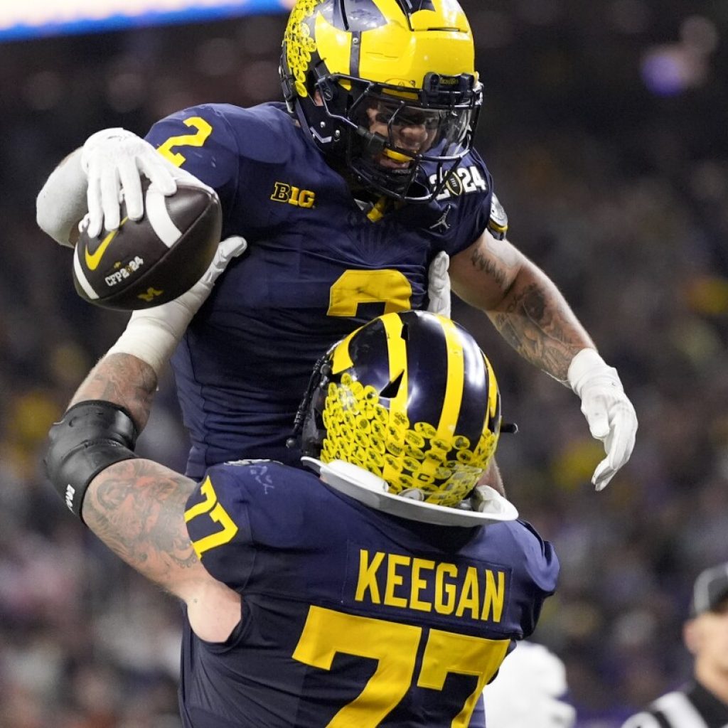 College Football: Michigan Wolverines beat Washington Huskies to win national title  | AP News