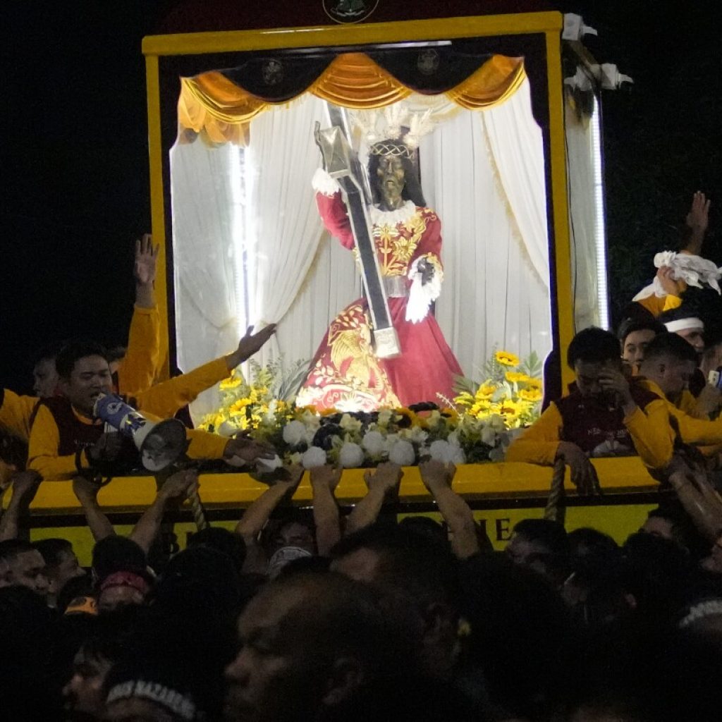 Filipino Catholics pray for Mideast peace in massive procession venerating a black statue of Jesus | AP News