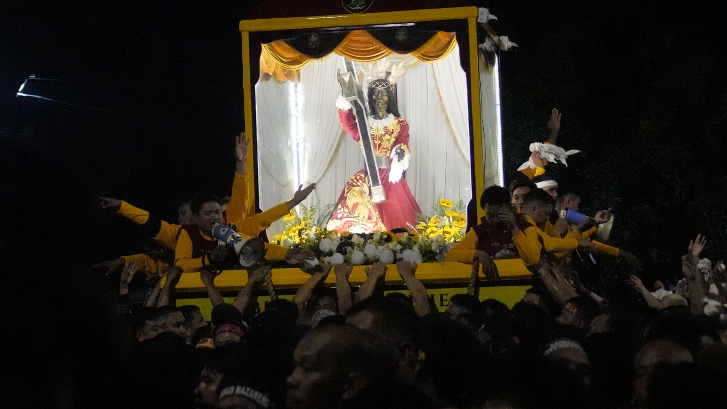 Filipino Catholics pray for Mideast peace in massive procession venerating a black statue of Jesus | AP News