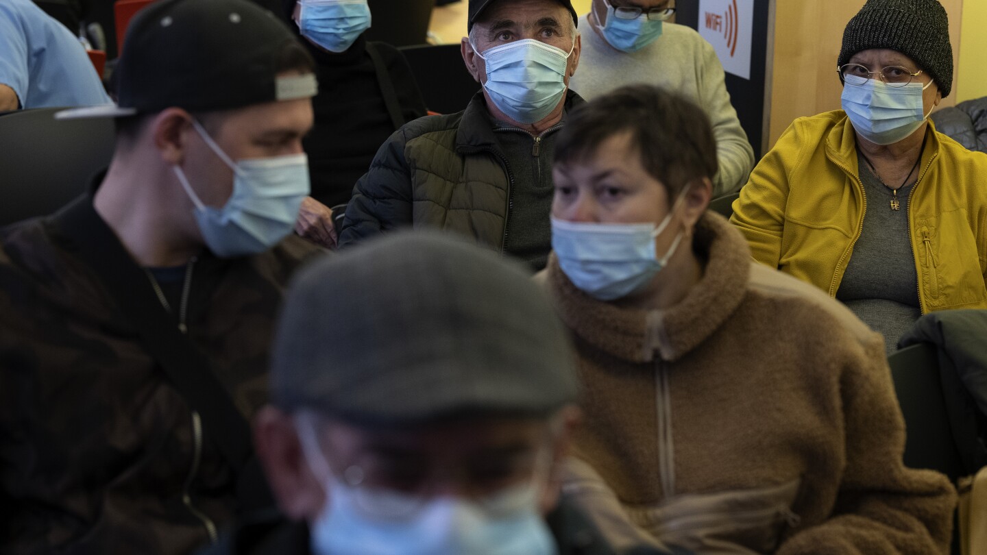 Spain makes face masks mandatory in hospitals and clinics after a spike in respiratory illnesses | AP News