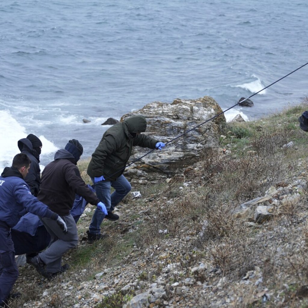 A dinghy carrying migrants hit rocks in Greece, killing 2 people in high winds | AP News