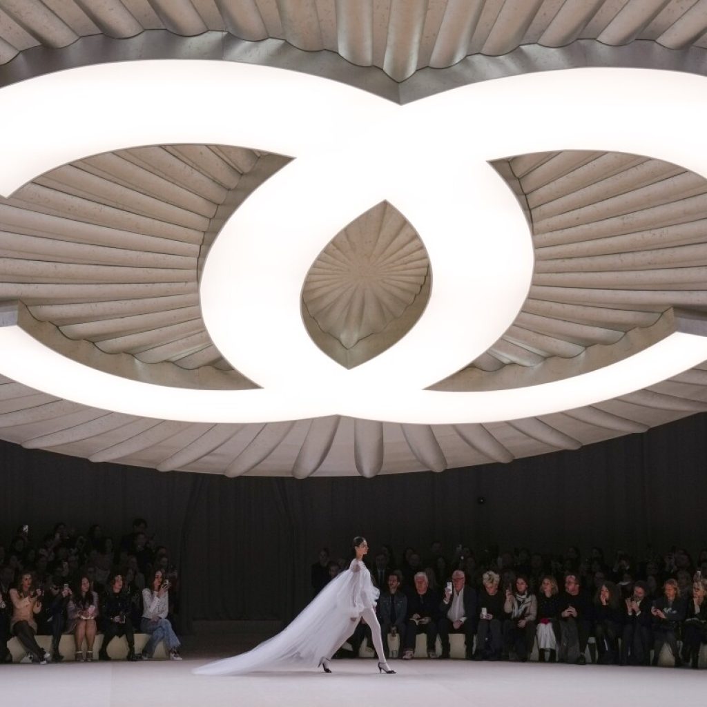 Chanel’s spring couture show is a button-inspired ballet on the Paris runway | AP News