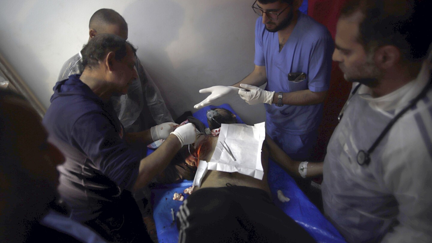 Gaza’s Health Ministry blames Israeli troops for deadly shooting as crowd waited for aid | AP News