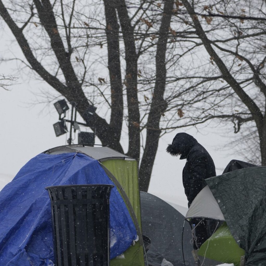 With beds scarce and winter bearing down, a tent camp grows outside NYC’s largest migrant shelter | AP News