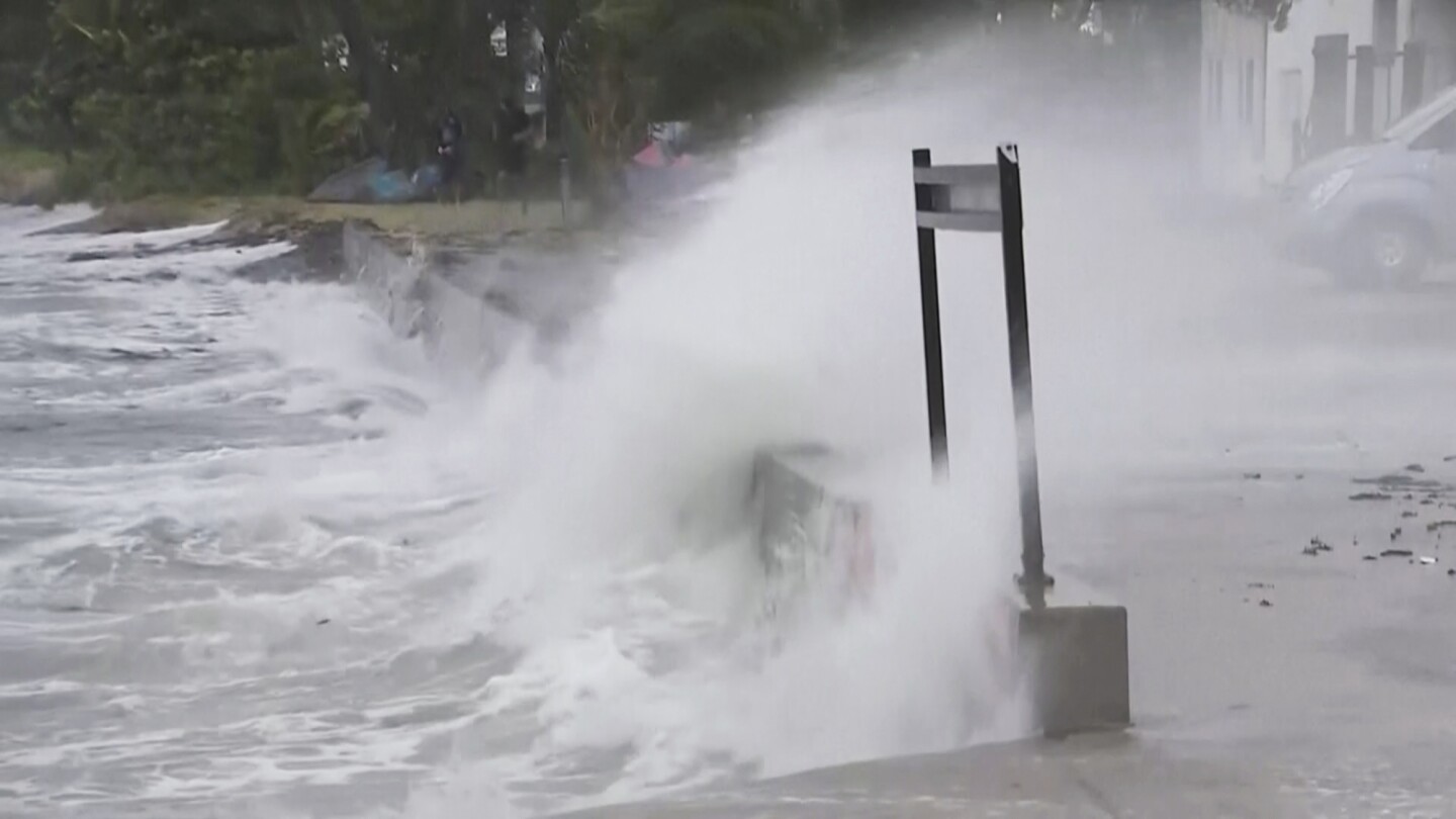 Storm hits Australia with strong winds and power outages, but weakens from cyclone to tropical storm | AP News