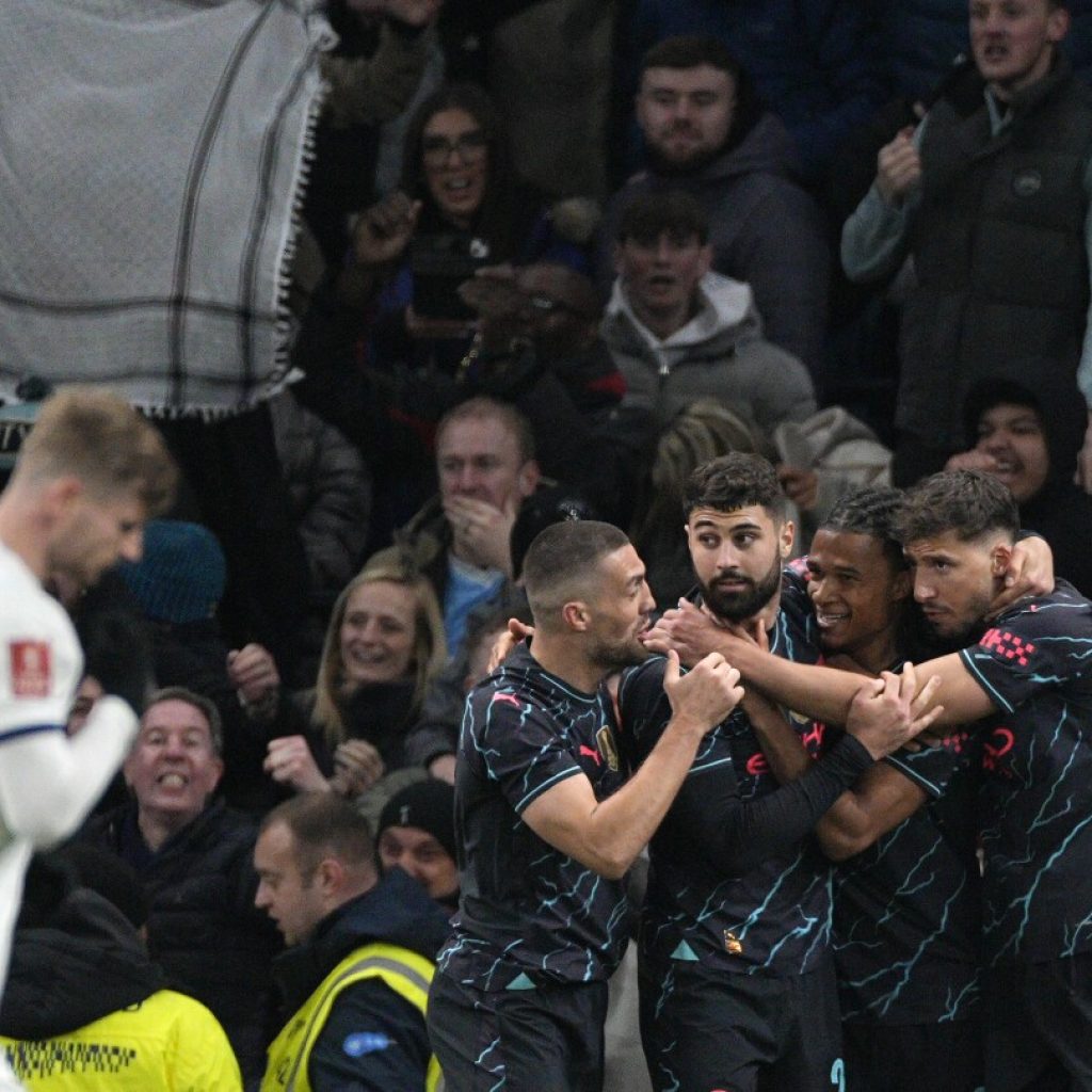 Ake keeps alive Man City treble trophy defense after beating Tottenham in the FA Cup | AP News