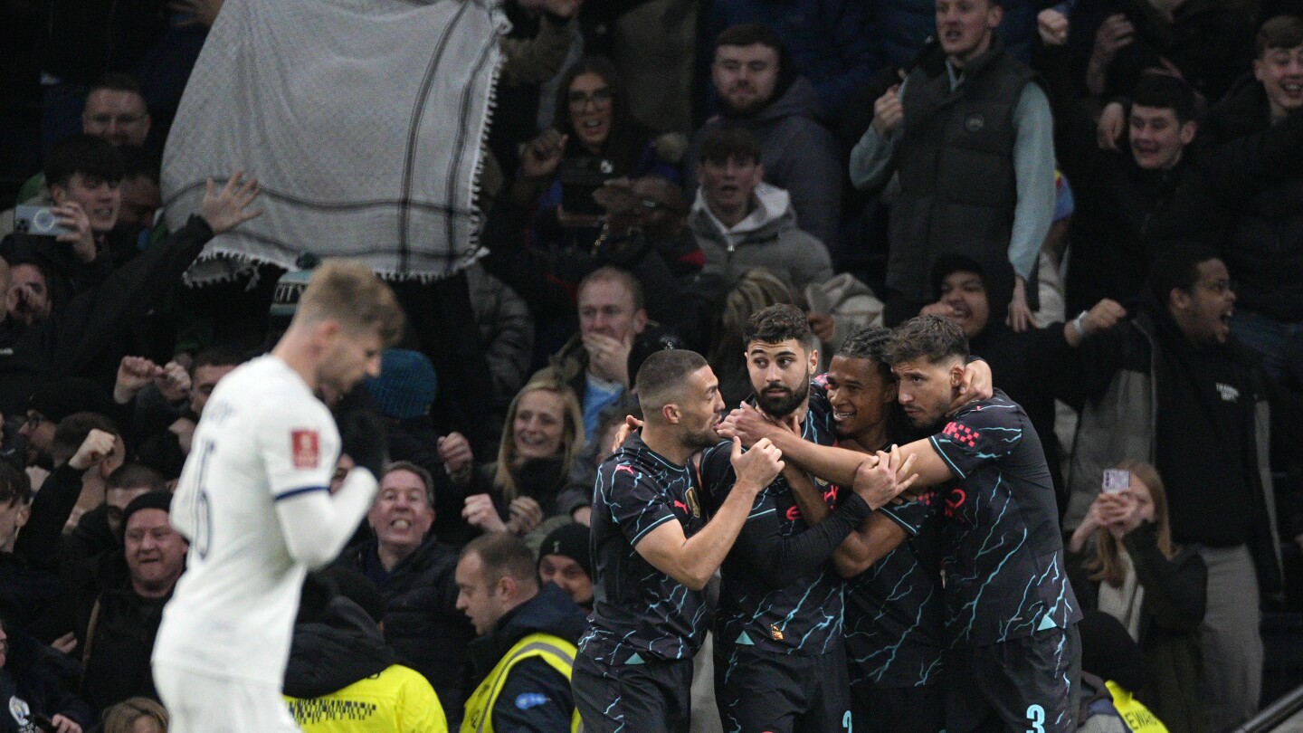 Ake keeps alive Man City treble trophy defense after beating Tottenham in the FA Cup | AP News