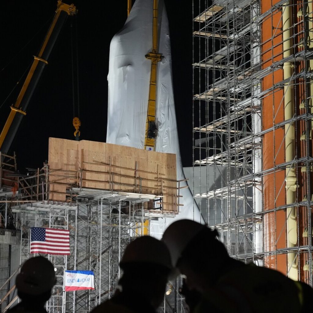 Space Shuttle Endeavour hoisted for installation in vertical display at Los Angeles science museum | AP News