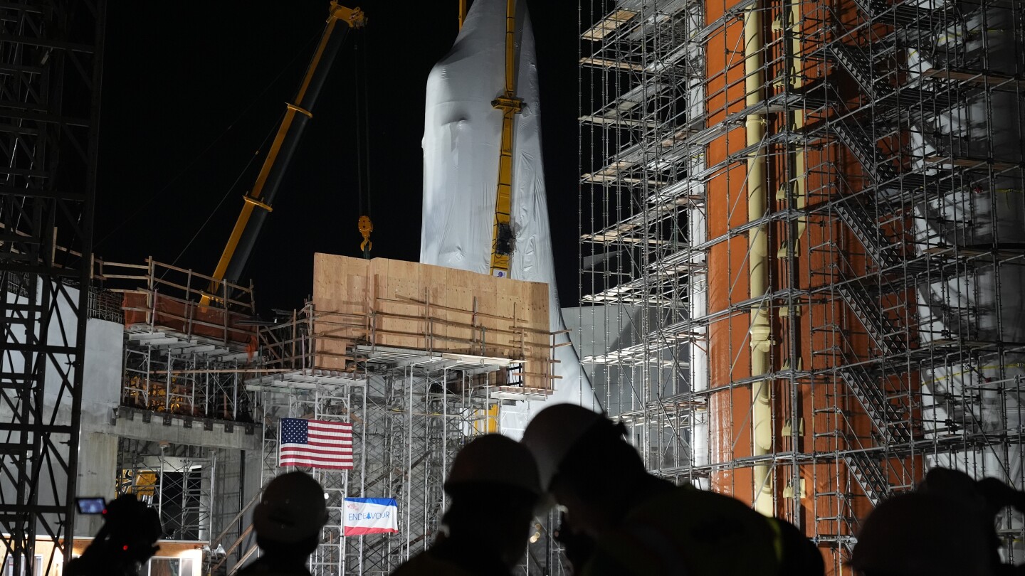 Space Shuttle Endeavour hoisted for installation in vertical display at Los Angeles science museum | AP News