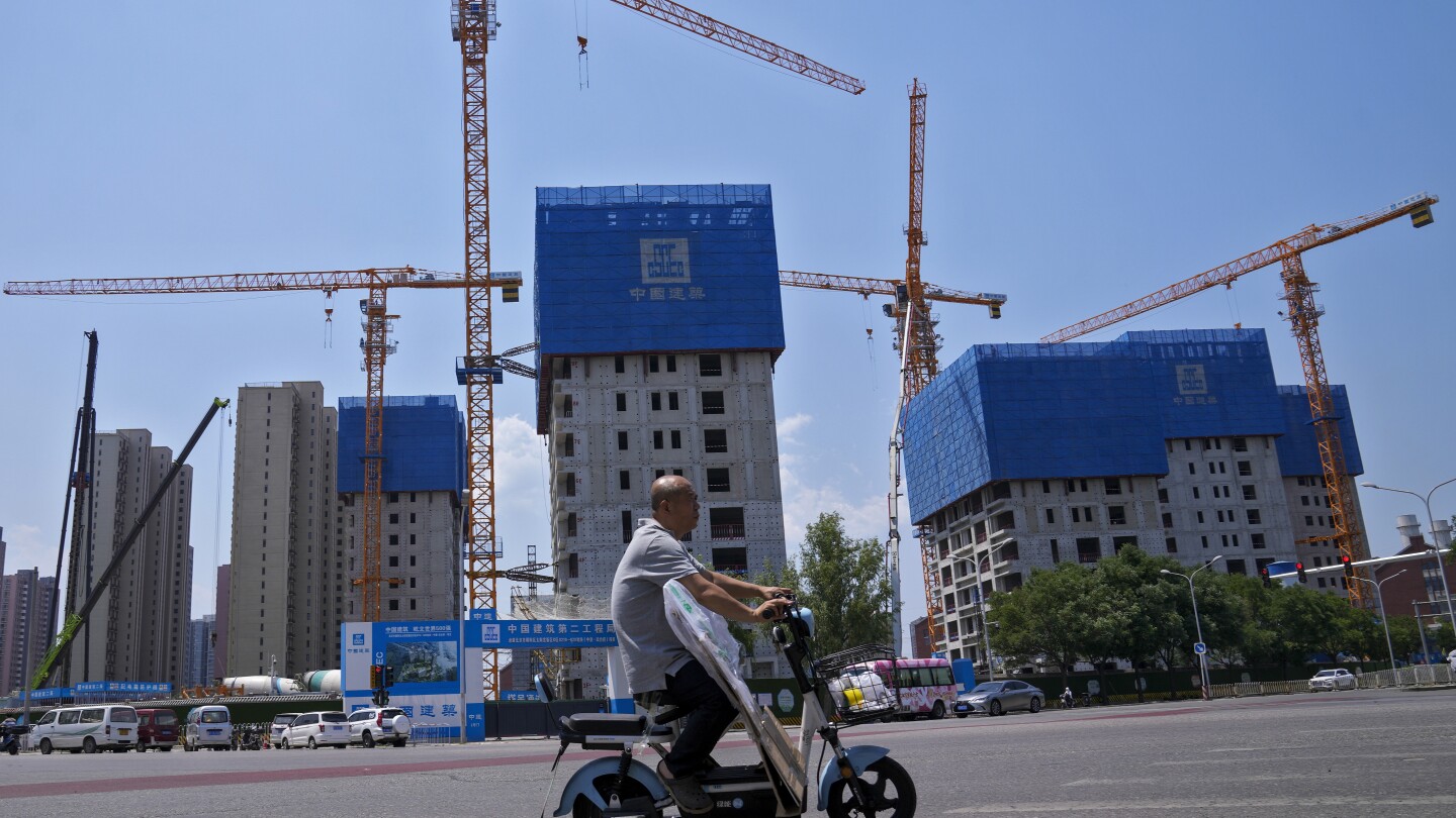 China pledges more help for its ailing property market, as IMF forecasts economy will slow | AP News