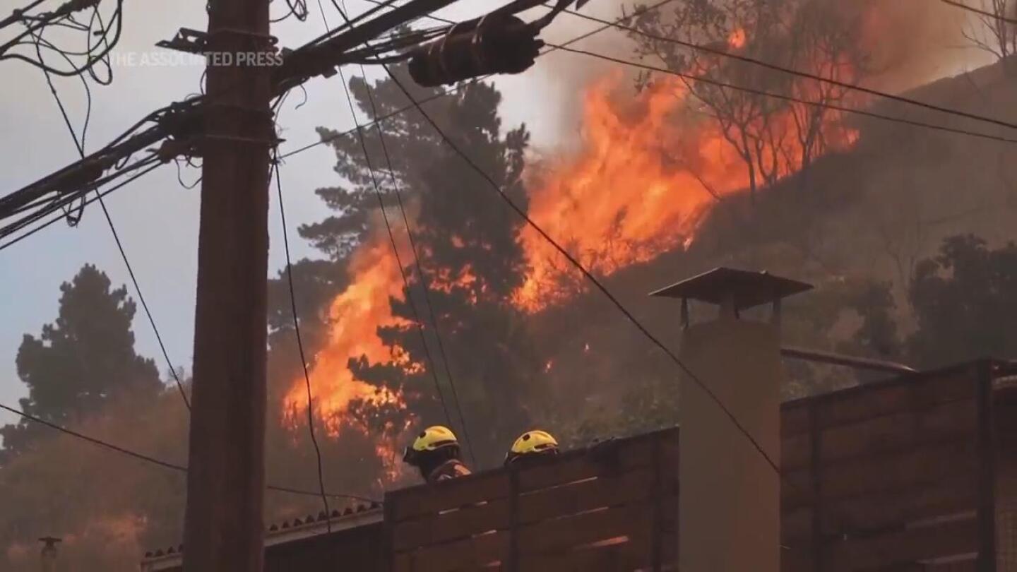 Dozens reported dead in Chile as forest fires move into densely populated central areas | AP News