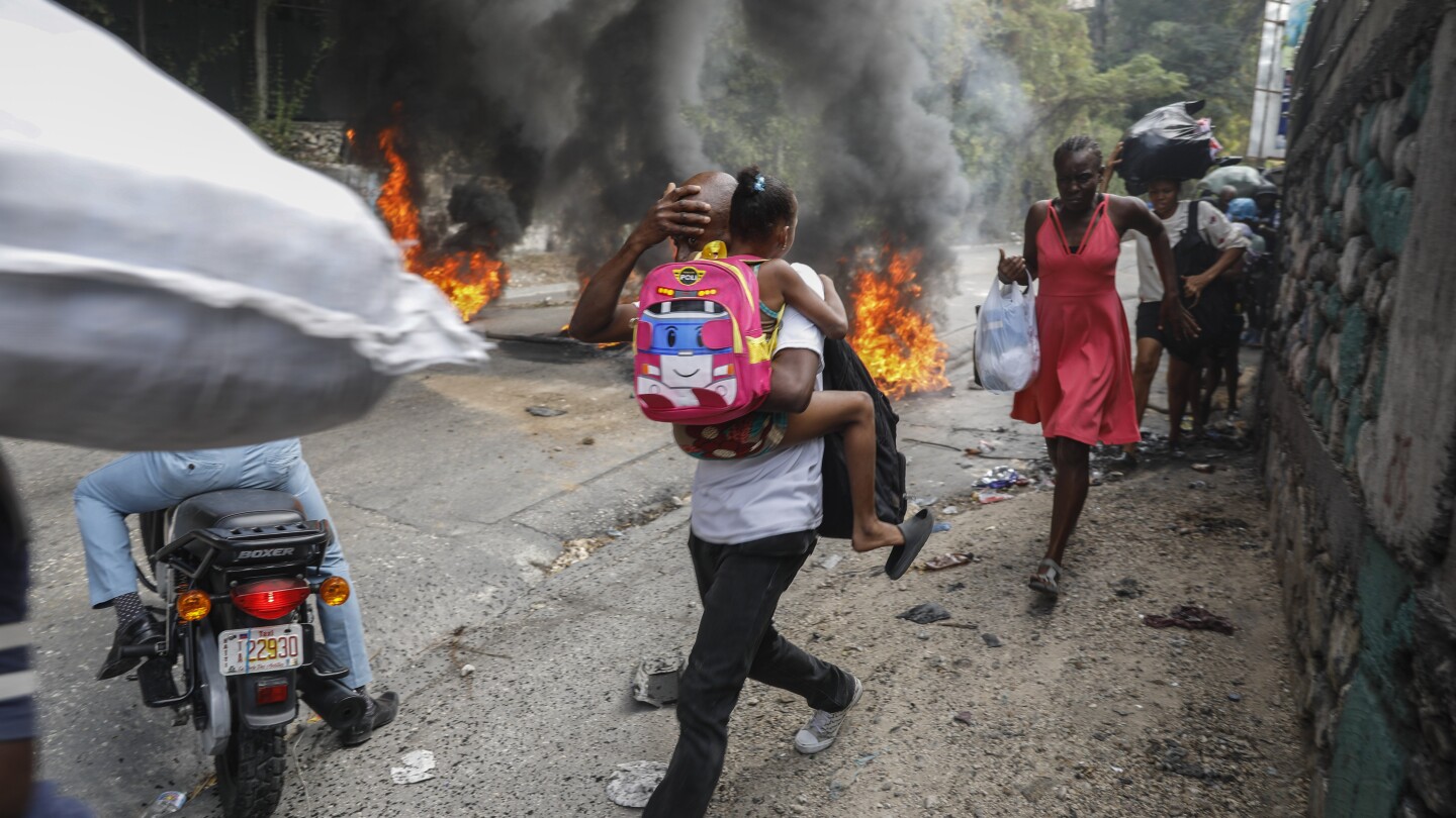 Former rebel leader arrives in Haiti’s capital as protests against prime minister gain momentum